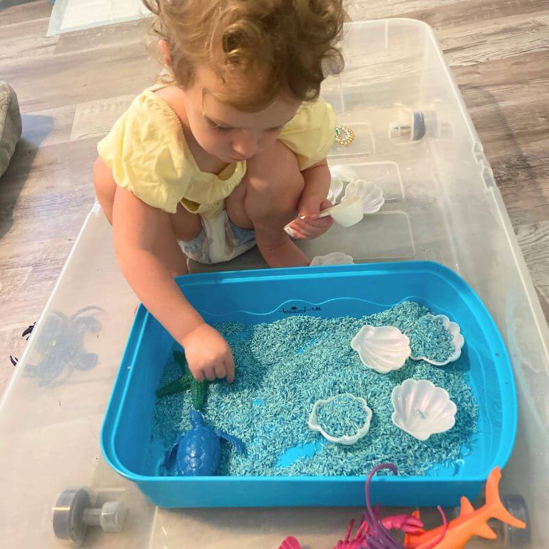 ruthie playing with ocean sensory bin