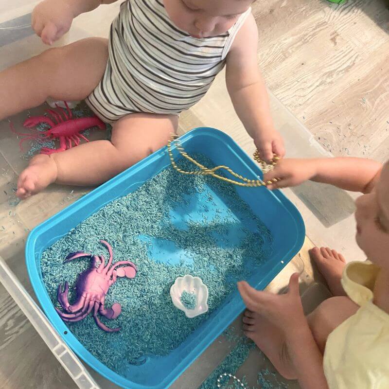 ruthie and klay playing with ocean sensory bin